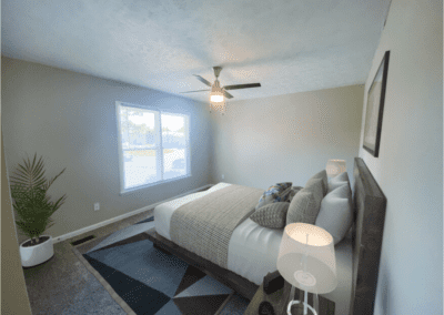 A staged bedroom with carpeted floors and elegant furniture