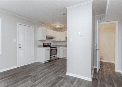 A view of the kitchen and downstairs bathroom