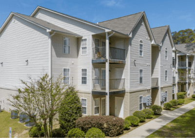 A three-story apartment building in the Woodland Ridge apartment community. Each unit has either a balcony or patio space