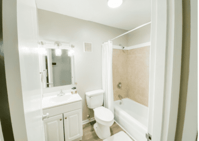 A clean, white bathroom with a tiled shower